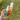 Two bottles of Camo insect repellent held in a hand with a grassy background.