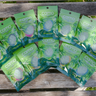 Multiple packages of Camo insect repellent bands on a wooden surface, with grass in the background.