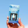 Camo insect repellent packaging held against a blue sky